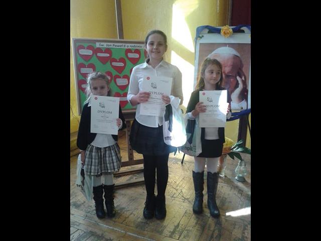 Laureatki powiatowego konkursu plastycznego prezentują swoje dyplomy.